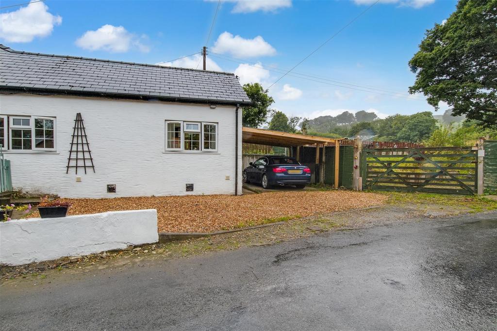 Front with parking and gate to garden
