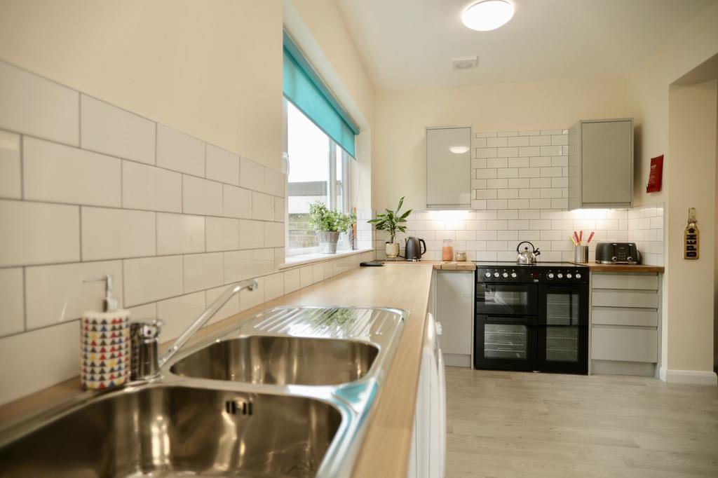 This bright and inviting kitchen features moder...