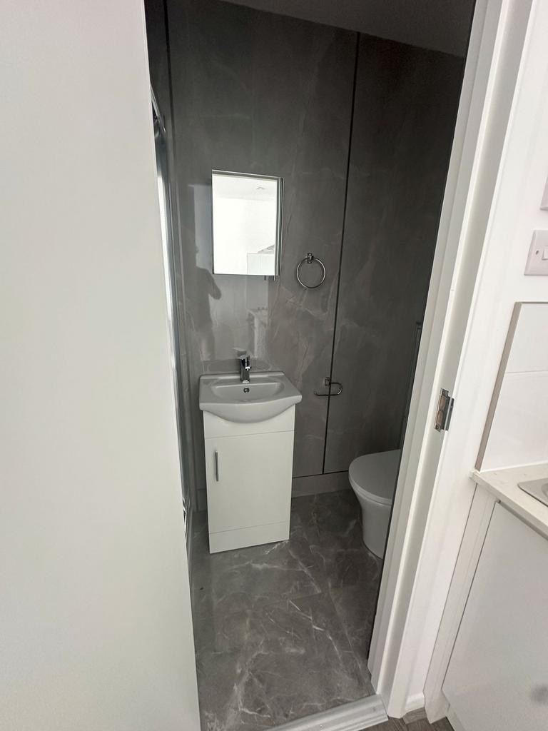 A modern bathroom featuring a sleek white sink ...