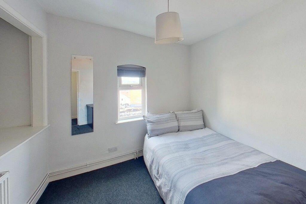 Cozy double bedroom featuring a comfortable bed...