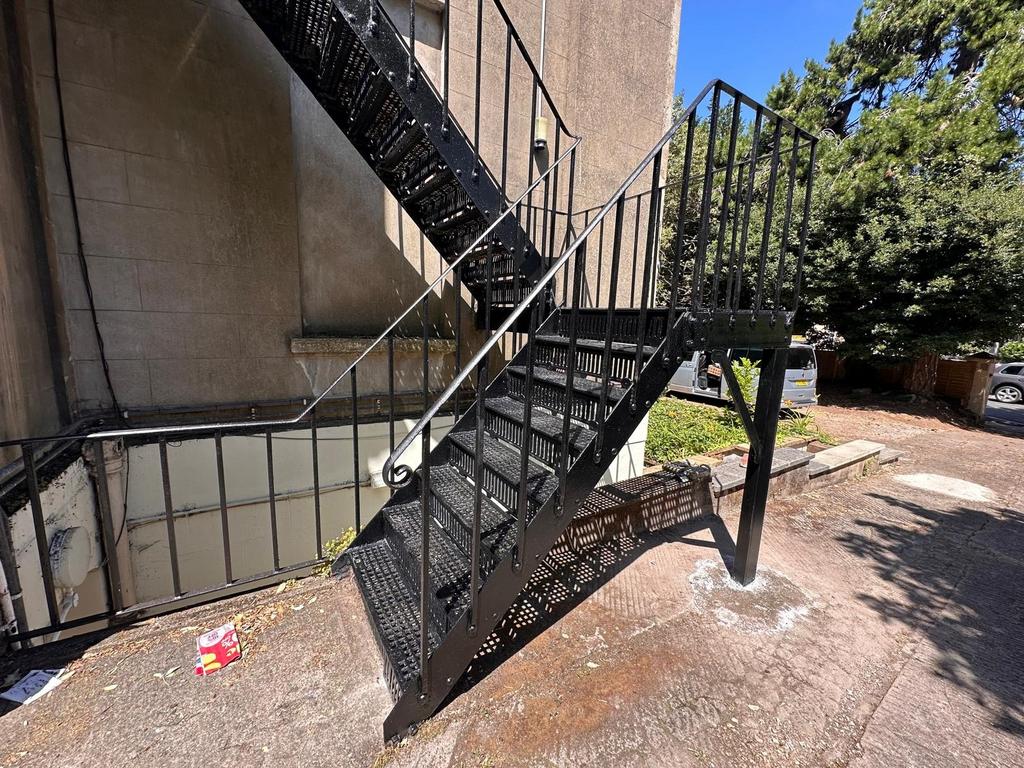 Outdoor metal fire escape staircase leading fro...