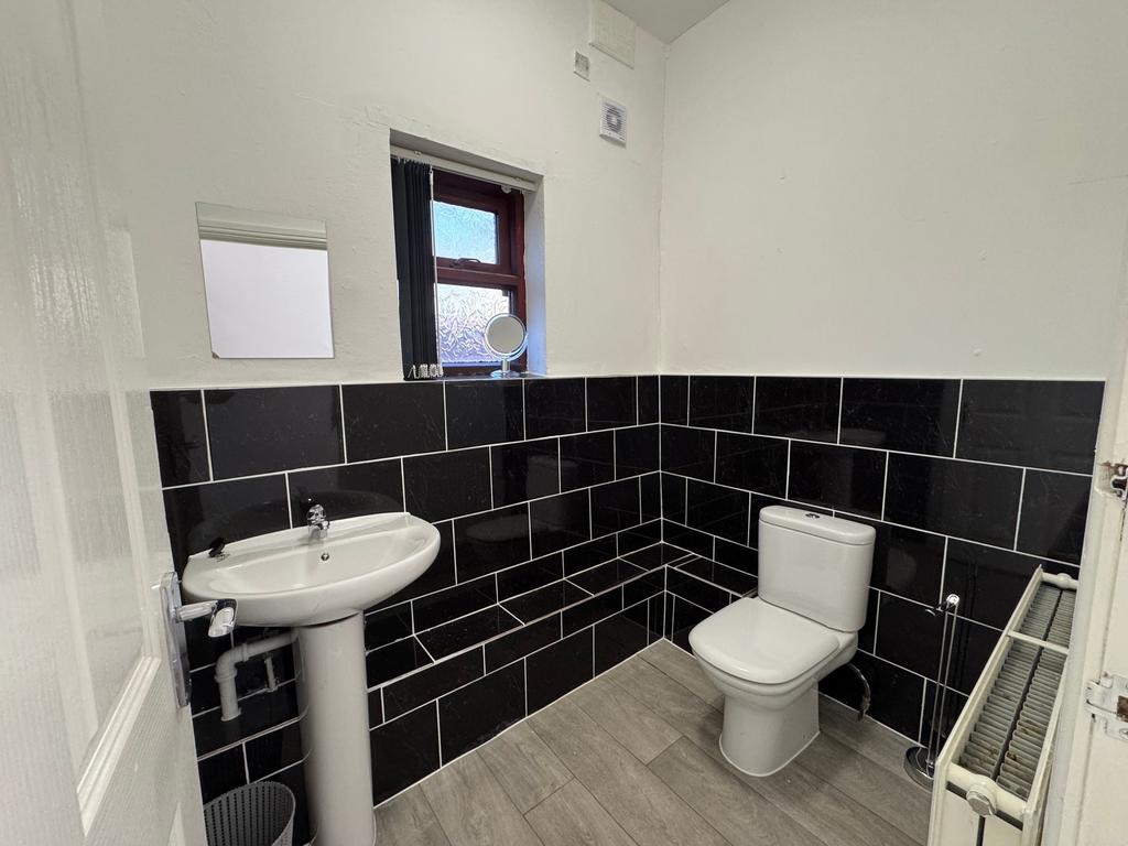 Bright and modern bathroom featuring stylish bl...