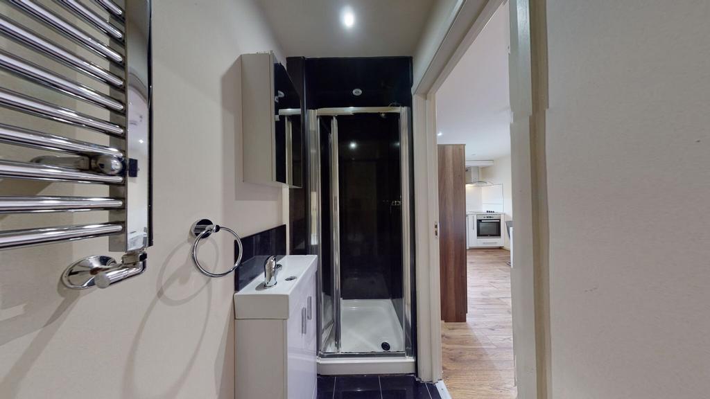 A modern bathroom featuring a sleek shower encl...