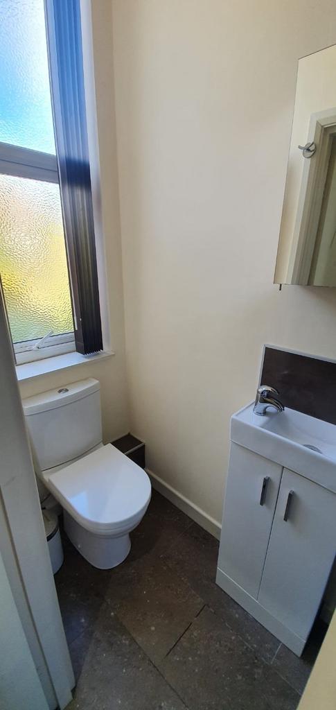 Bright and clean small toilet featuring a moder...