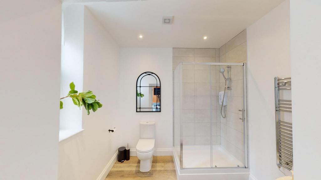 A bright and modern bathroom featuring a spacio...