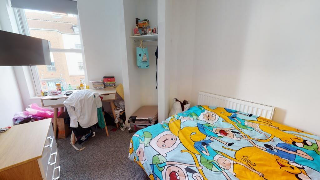 A cozy double bedroom featuring a vibrant blank...