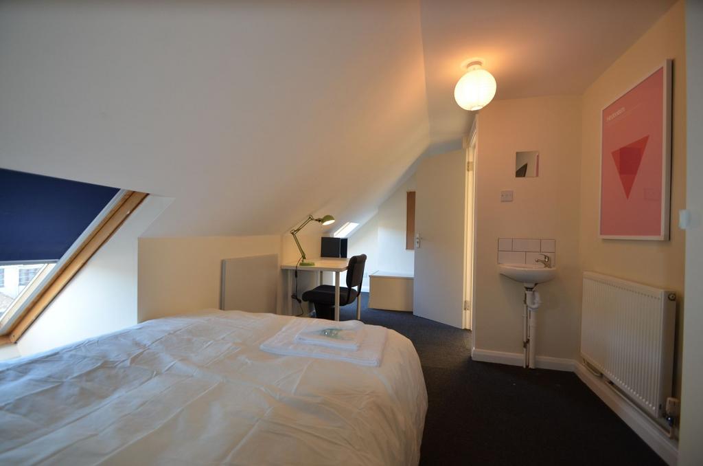 This charming double bedroom features a cozy at...