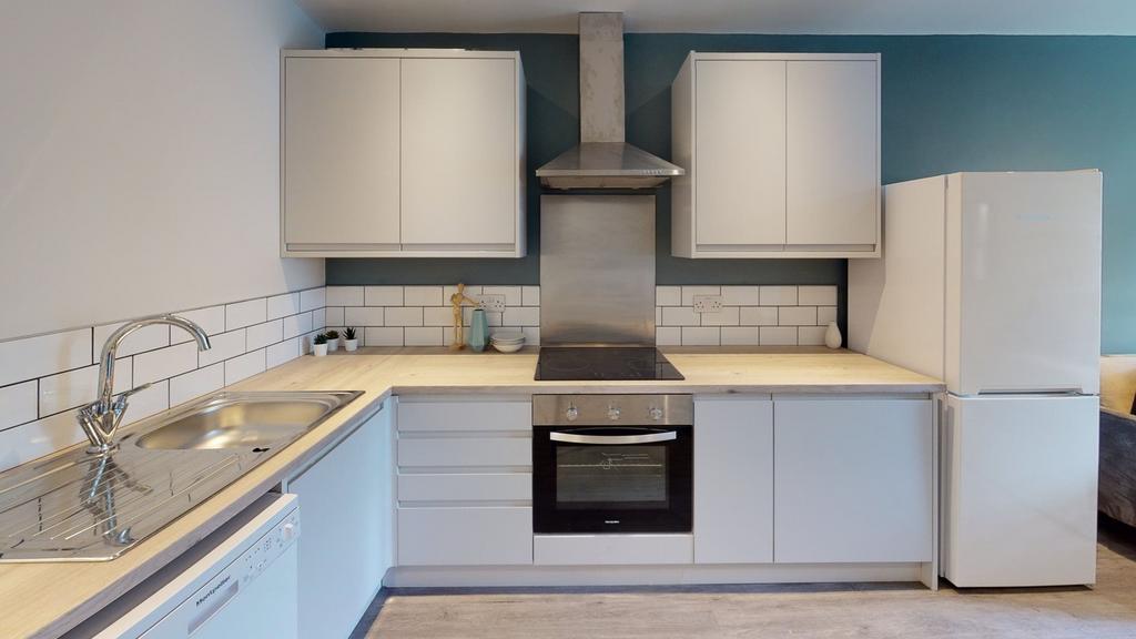 A modern and clean kitchenette with ample stora...