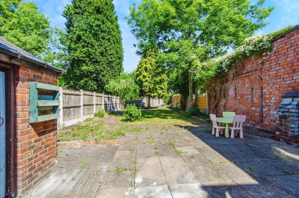 Outbuilding &amp; paved rear garden area.jpeg