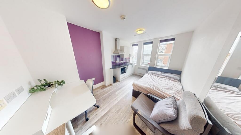 This inviting double bedroom features a cozy la...