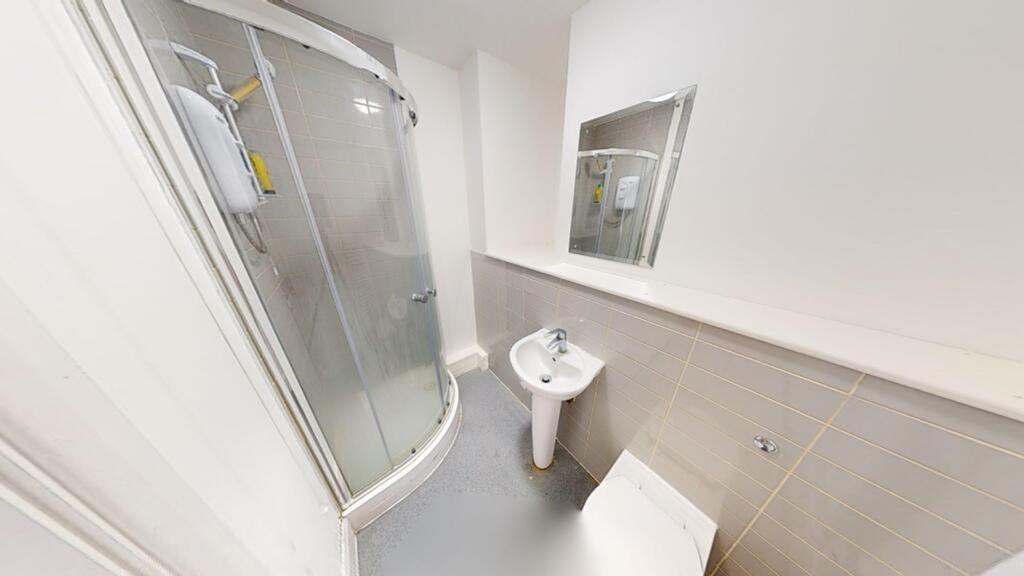 Bright and modern bathroom featuring a sleek sh...