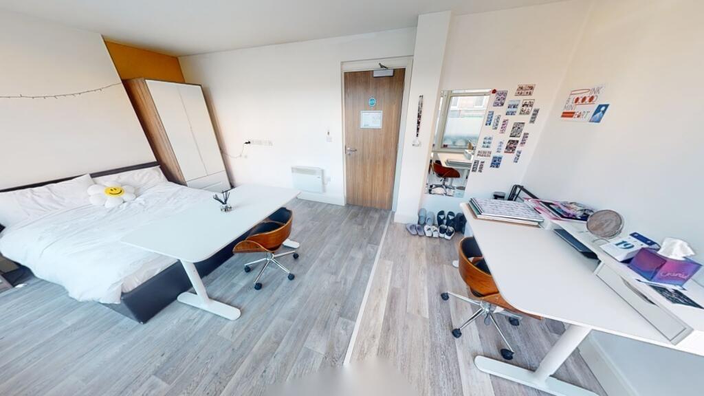 Bright and inviting bedroom featuring a comfort...