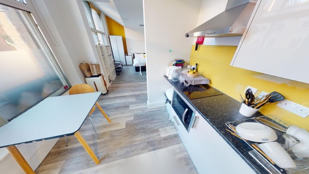 A modern, well-lit kitchen featuring sleek cabi...