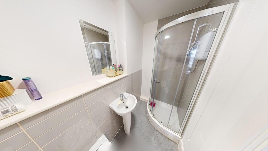 A clean and modern bathroom with a shower enclo...