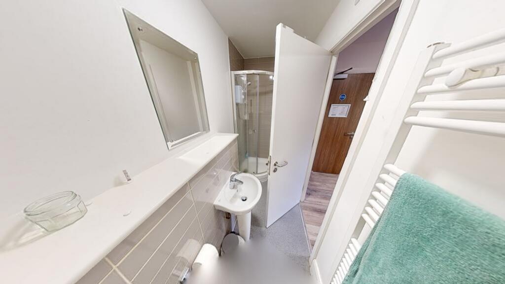 A modern bathroom featuring a sleek shower, cle...