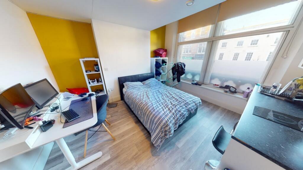 A bright and spacious double bedroom featuring ...