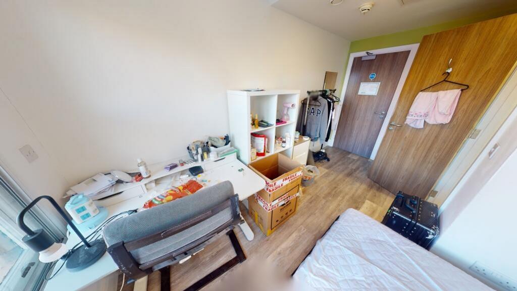 A cozy double bedroom featuring a comfortable b...