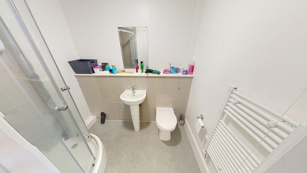 This modern bathroom features a spacious shower...