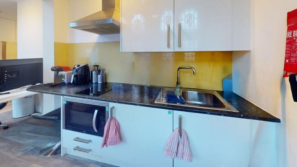 A modern kitchen featuring sleek cabinetry, amp...