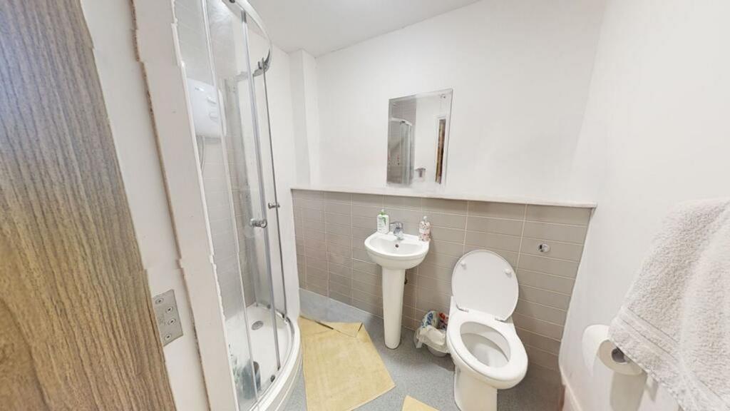 A modern bathroom featuring a sleek shower, sty...