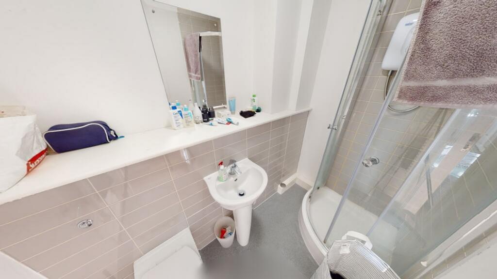 Bright and modern bathroom featuring a sleek sh...