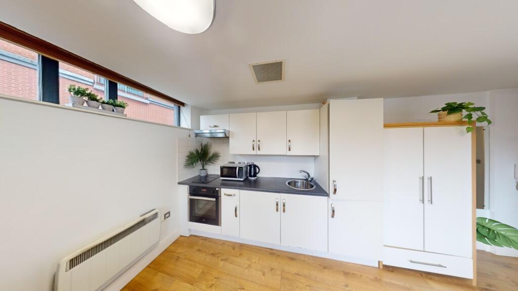 Bright and modern kitchen featuring sleek white...