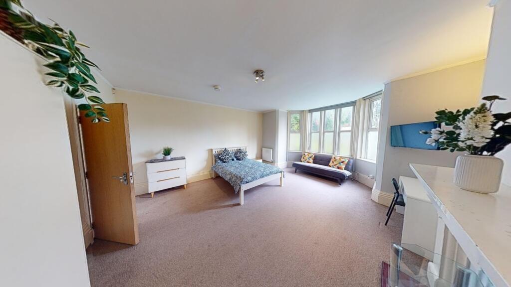 A spacious and inviting master bedroom featurin...