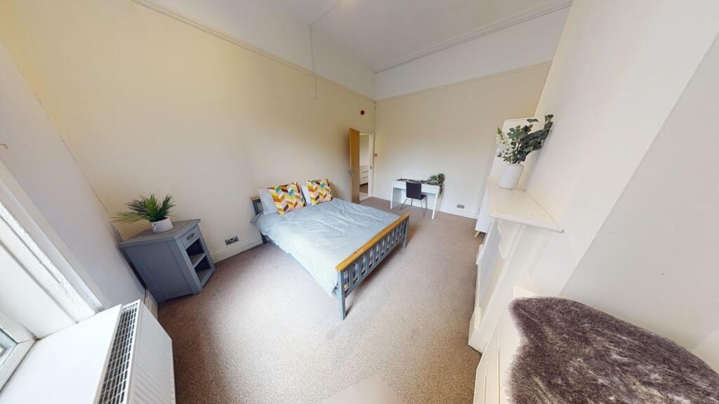 A bright and spacious master bedroom featuring ...