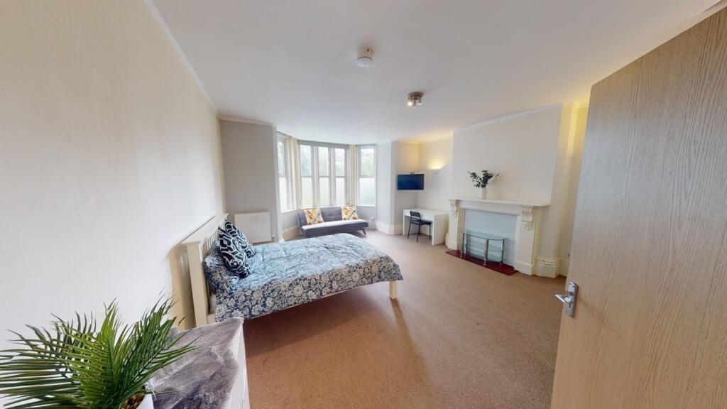 Bright and spacious master bedroom featuring a ...