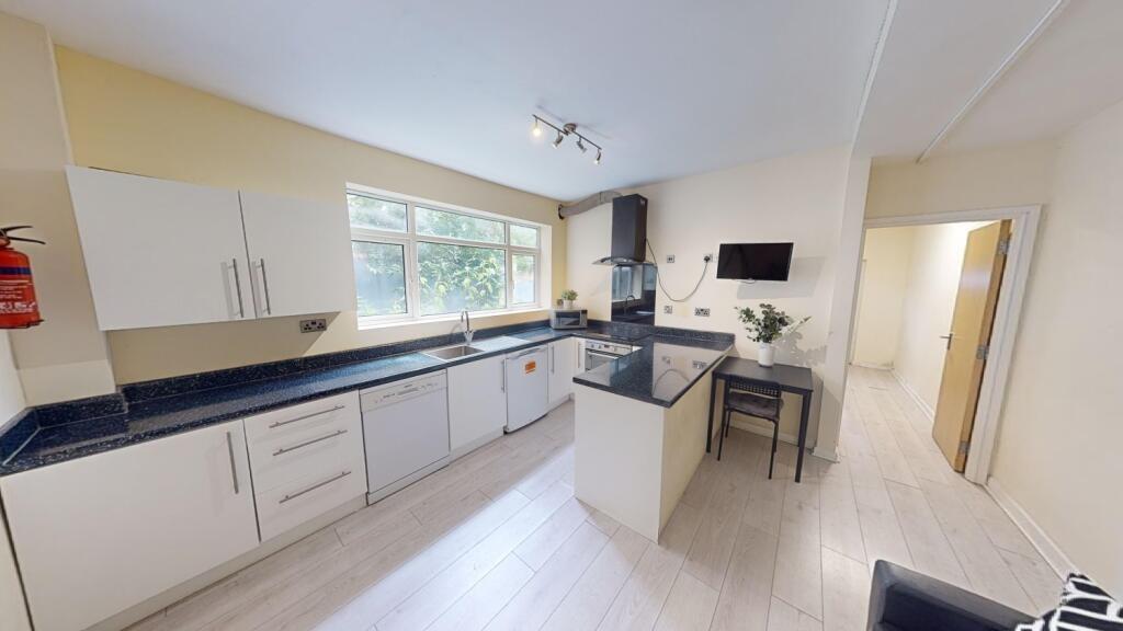 Bright and modern kitchen featuring ample count...