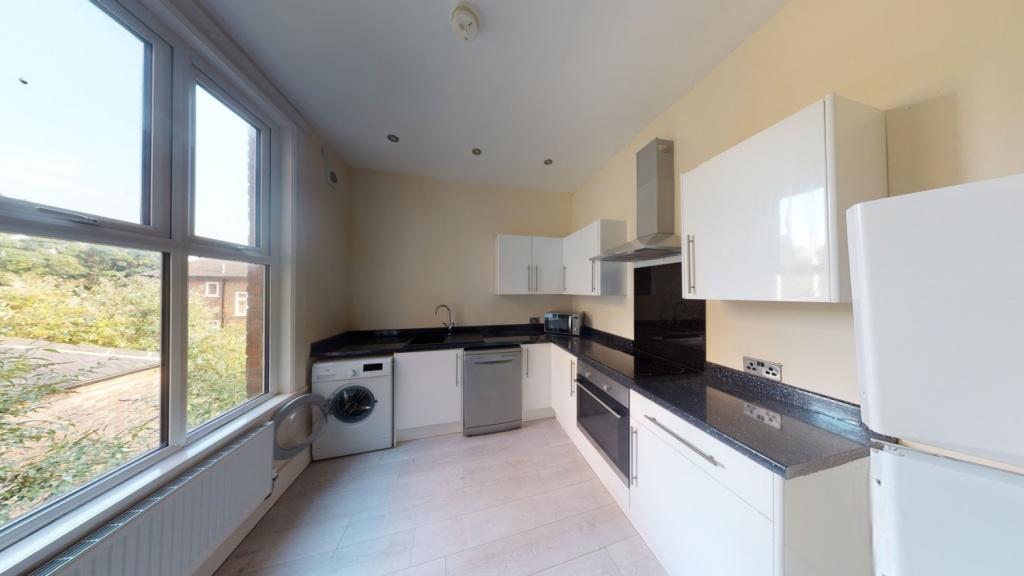 Bright and modern kitchen featuring ample natur...
