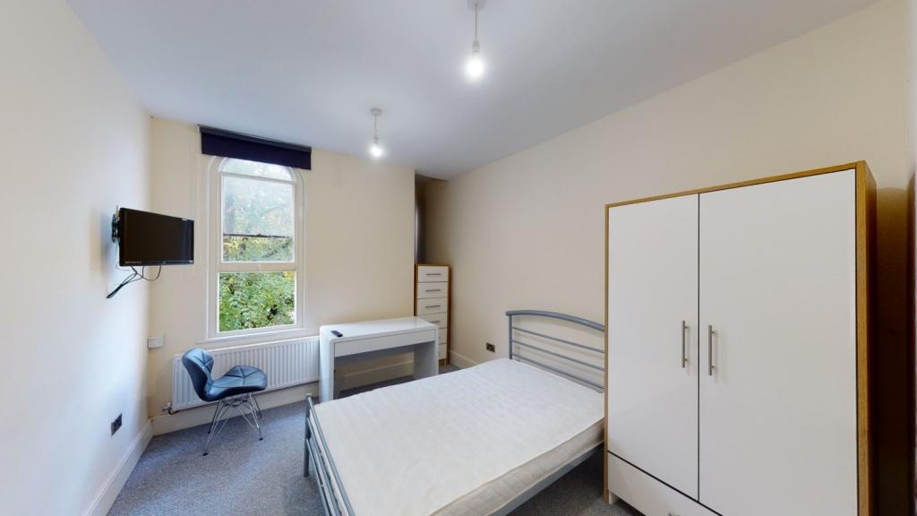 Bright and tidy double bedroom featuring a comf...