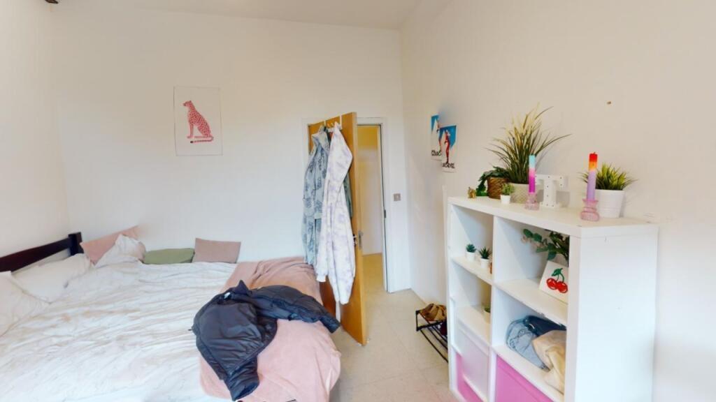 Bright and cozy master bedroom featuring a comf...