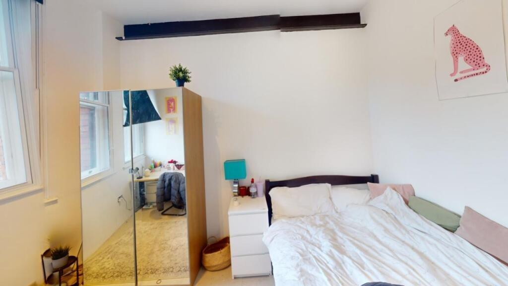 Bright and cozy double bedroom featuring a comf...