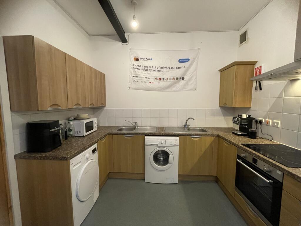 A modern, well-maintained kitchen featuring woo...