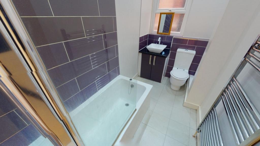 A modern bathroom featuring a bath and shower, ...