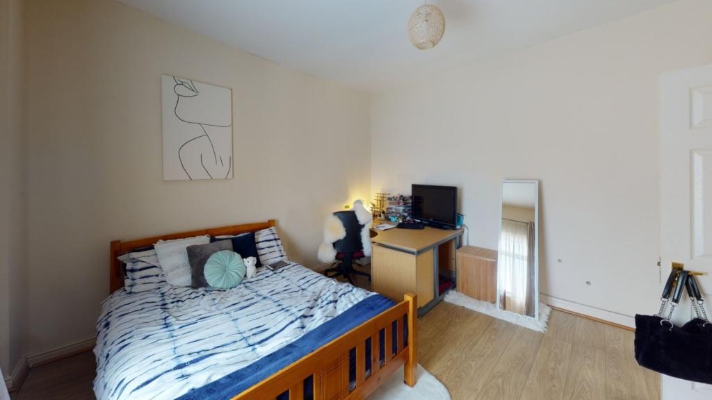 A bright and tidy double bedroom featuring a wo...