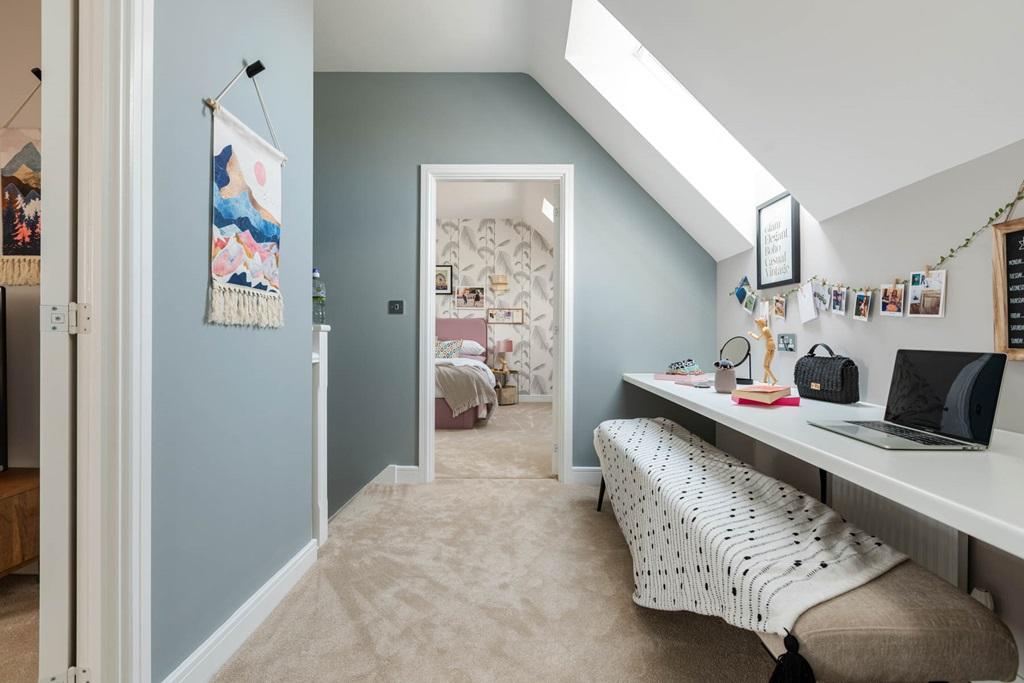 A desk and dressing table area maximise the...