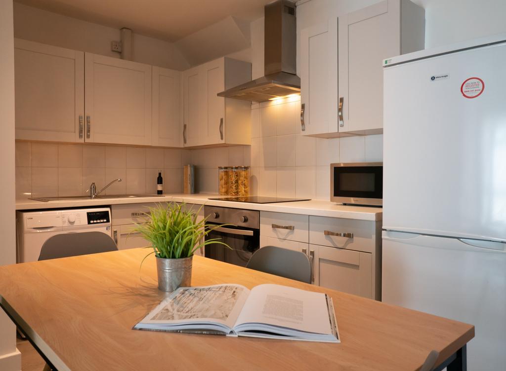 Bright and modern kitchen with ample storage, f...