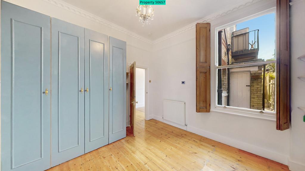 Large bedroom with window shutters
