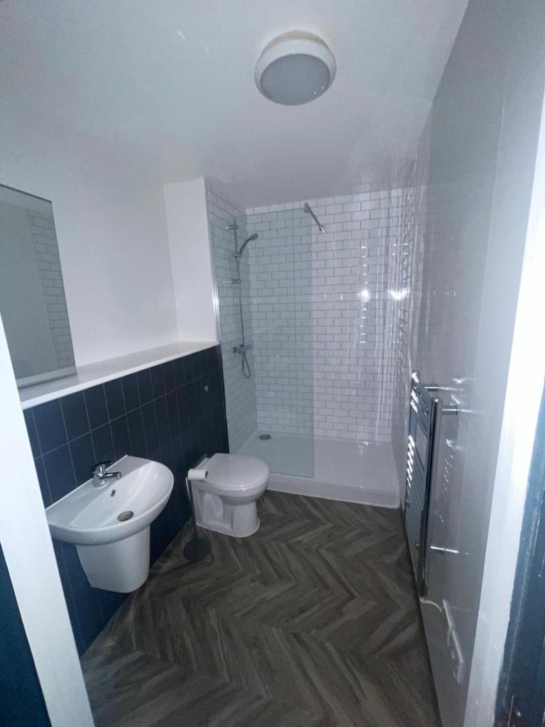 A modern bathroom featuring a walk-in shower wi...