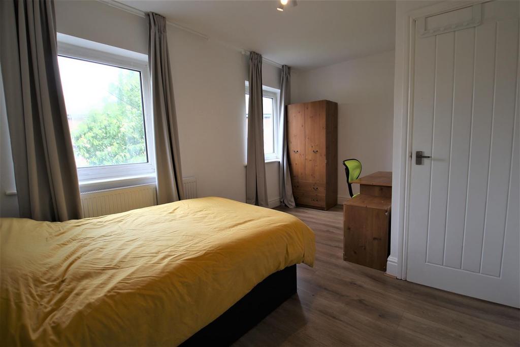 Bright and airy double bedroom featuring two la...