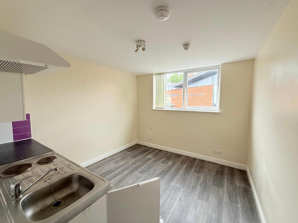 A bright and tidy kitchen space featuring moder...