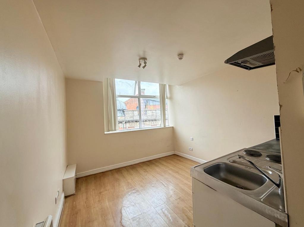 Bright kitchen area featuring a large window th...