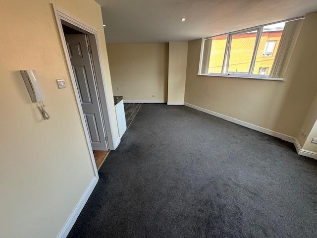 Bright and spacious living room with large wind...