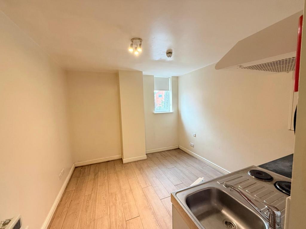 A compact kitchen area featuring a stainless st...