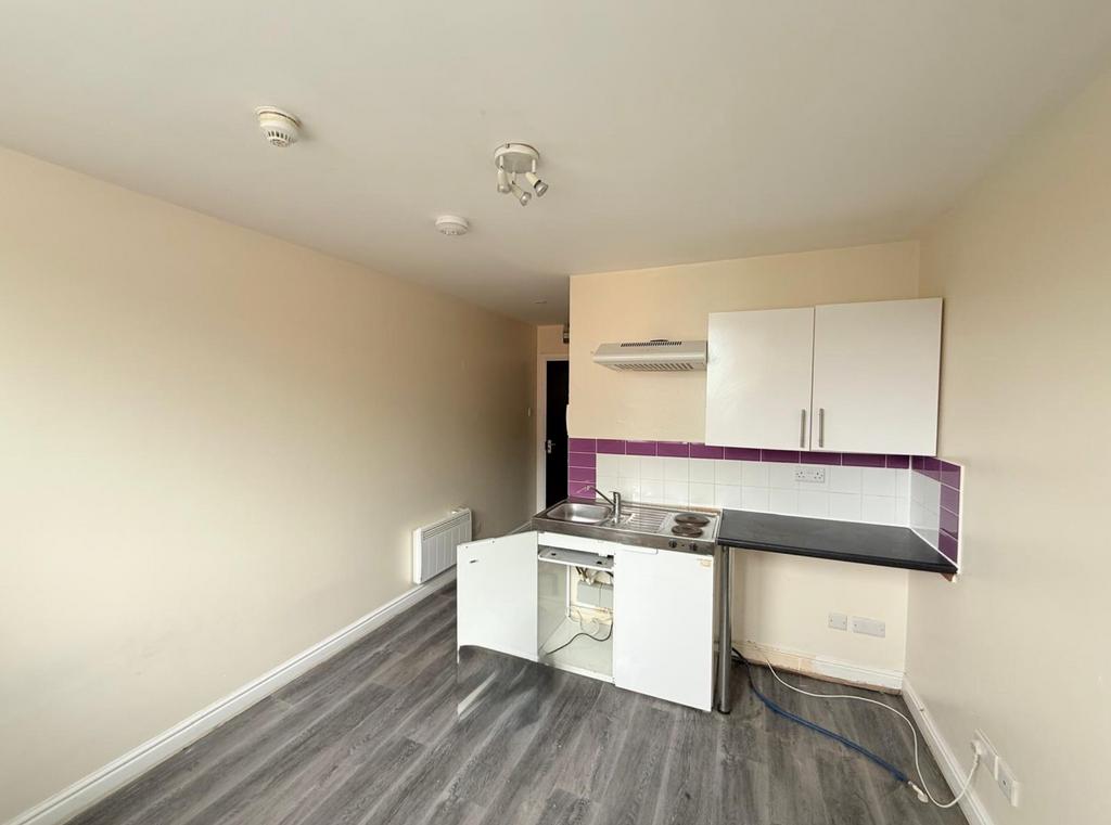 A compact kitchen area featuring clean laminate...