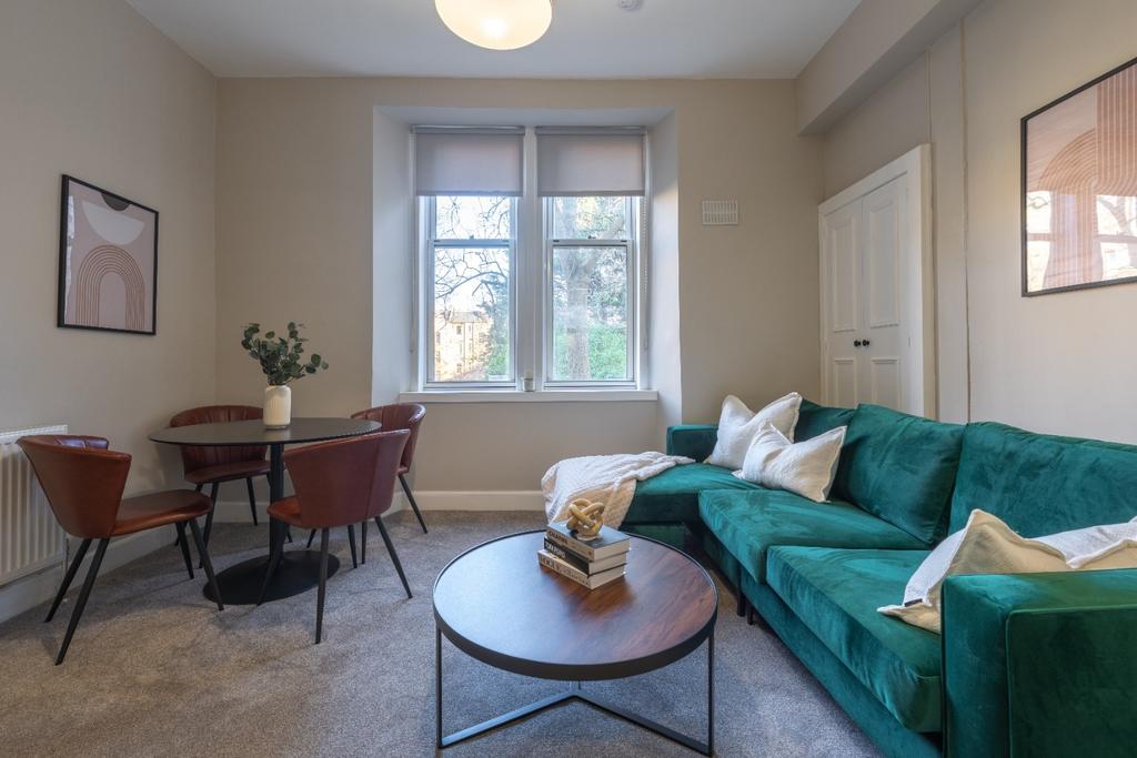 A cozy living room featuring a vibrant green so...