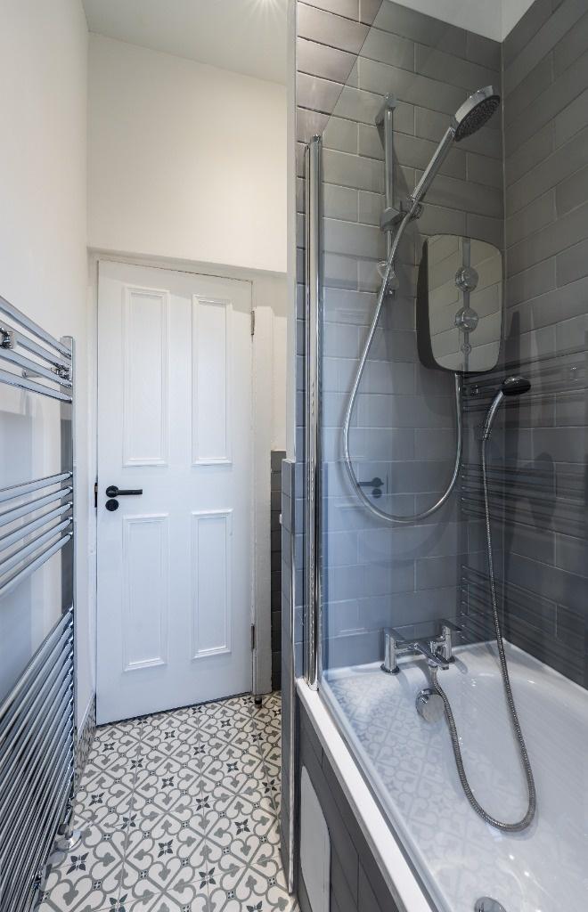 Modern bathroom featuring a sleek bathtub with ...