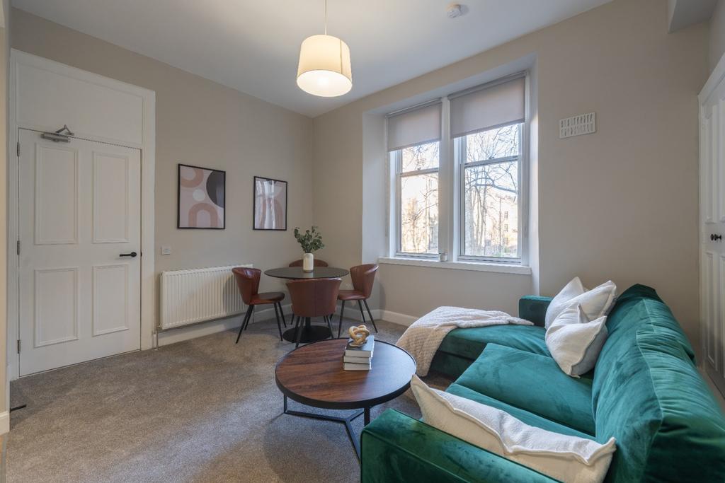 A cozy and inviting living room featuring a plu...